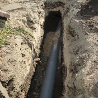 A new poly pipe laid in an open trench